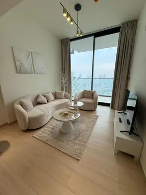 a living room with a couch and a table at Luxury 1BR Apartment In Binghatti Corner, High Floor In JVC in Dubai