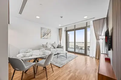 a living room with a table and chairs and a couch at YOUR STAY CORPORATE RESIDENCES DIFC Burj Daman in Dubai