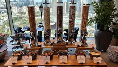 a display of bowls of food on a table in front of a window at YOUR STAY CORPORATE RESIDENCES DIFC Burj Daman in Dubai