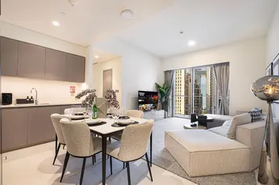 a kitchen and living room with a table and chairs at Luxury 2BR Downtown Dubai, Grande Signature with Stunning Burj Khalifa and Dubai Opera Views, steps to Dubai Mall by La Brisa in Dubai