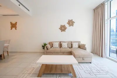 a living room with a couch and a table at Nivis find- Bay square -1 BHK in Dubai