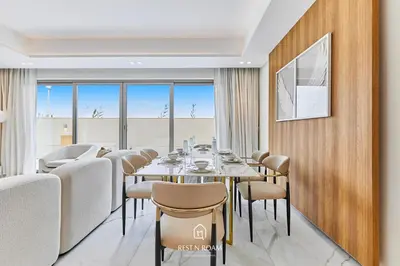 a dining room with a table and chairs at Luxury Elie Saab 3BR Villa in Jasmine Lane in Dubai