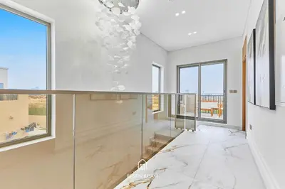 a room with glass walls and windows and a marble floor at Luxury Elie Saab 3BR Villa in Jasmine Lane in Dubai