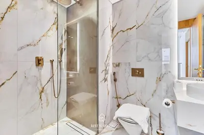 a bathroom with a shower and a toilet and a sink at Luxury Elie Saab 3BR Villa in Jasmine Lane in Dubai