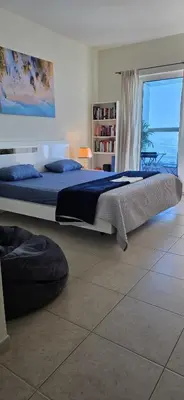 a bedroom with two beds and a view of the ocean at Elite Residence, Marina in Dubai