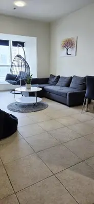 a living room with a couch and a table at Elite Residence, Marina in Dubai