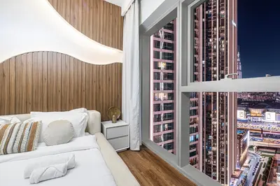 a bedroom with a view of a city at Modern Downtown Apartment plus Pool plus Khalifa View in Dubai