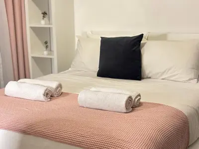 a bed with two rolled towels on top of it at 810 Elegant Marina View Apartment Near Tram, Dining & Nightlife, Bay Cental in Dubai