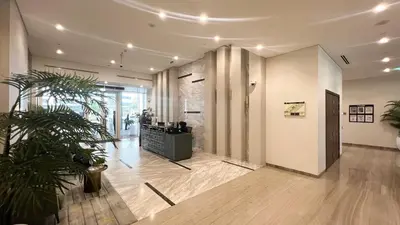 a lobby with a potted plant in a building at Stunning Canal View 1BR Apartment Burj Khalifa And Dubai Mall 10 Min Walk Ideal for Up to 4 Guests in Dubai