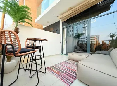 a living room with a couch and a table at Nature luxe estudio Dubai in Dubai