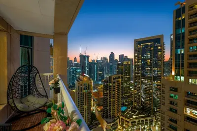 a view of a city skyline at night from a balcony at Downtown 1BR Full Burj Khalifa & Fountain Views in Dubai