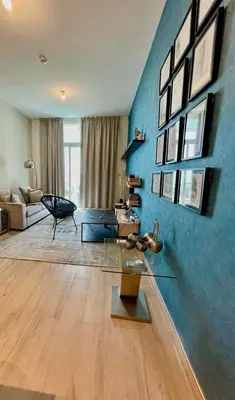 a living room with a blue wall at Luxury Apartment Marina in Dubai