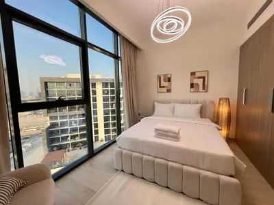 a bedroom with a large bed and large windows at Urban SkyView Apartment Near Downtown Dubai in Dubai