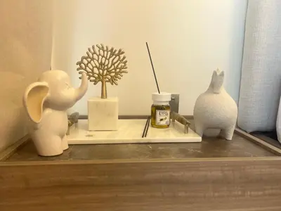 a shelf with vases and a plant on it at Urban SkyView Apartment Near Downtown Dubai in Dubai