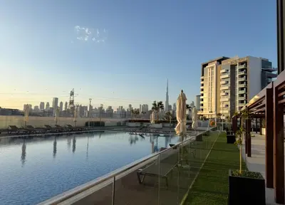 a pool of water with a city in the background at Urban SkyView Apartment Near Downtown Dubai in Dubai