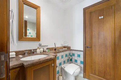 a bathroom with a toilet and a sink and a mirror at 5 Minutes Dubai Mall - Burj Khalifa - View pools in Dubai