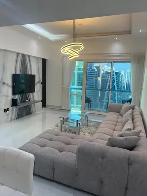 a living room with a large couch and a table at Stunning Modern 1BR Apartment Lake View JLT Lake Terrace in Dubai