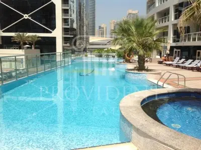 a large blue swimming pool in a building at Stunning Modern 1BR Apartment Lake View JLT Lake Terrace in Dubai