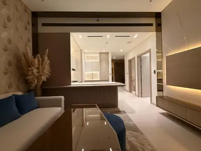 a living room with a couch and a table at The Royale Mocha Jacuzzi Suite 34-10 I JVC I Dar Oasis in Dubai
