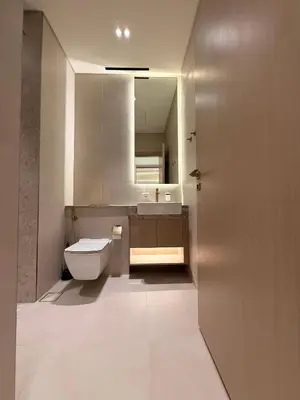 a bathroom with a toilet and a sink and a mirror at The Royale Mocha Jacuzzi Suite 34-10 I JVC I Dar Oasis in Dubai