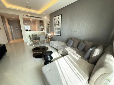 a living room with a couch and a table at AMAKIN Damac Paramount in Dubai