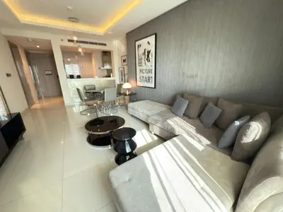 a living room with a couch and a table at AMAKIN Damac Paramount in Dubai