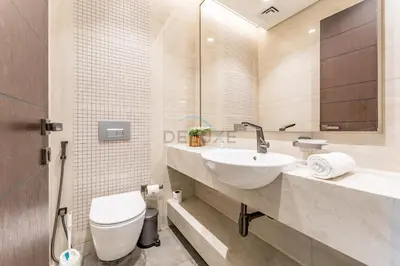 a white bathroom with a sink and a toilet at City Living with Street Views, Just a Walk to Bus Stop, Easy Transport to Burj Khalifa and Dubai Mall, Nobles Tower, Business Bay by Deluxe Holiday Homes in Dubai