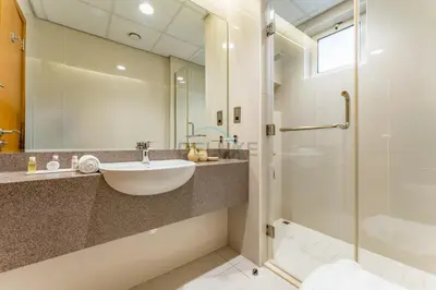 a bathroom with a sink and a shower at 4BR plus Maids Room Villa Near Nad Al Sheba Mall, With Easy Access to Major Dubai Attractions - Nad Al Shiba Third, Nad Al Sheba by Deluxe Holiday Homes in Dubai