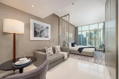 a living room with a couch and a bed at Dubai Water Canal View, Minutes away from Burj Khalifa and Dubai Mall, Near Metro Bus Station - Prive by Damac B, Business Bay by Deluxe Holiday Homes in Dubai