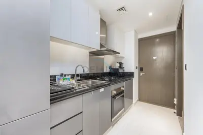 a kitchen with a sink and a stove at Dubai Water Canal View, Minutes away from Burj Khalifa and Dubai Mall, Near Metro Bus Station - Prive by Damac B, Business Bay by Deluxe Holiday Homes in Dubai