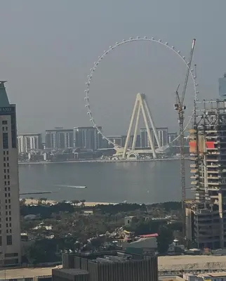 a view of a ferris wheel in a city at Elite Residence, Marina in Dubai