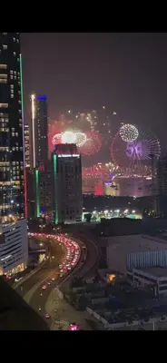 a city skyline at night with traffic on a freeway at Elite Residence, Marina in Dubai