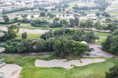 an aerial view of a golf course with trees at Modern Retreat in The Views with Balcony & Pool in Dubai