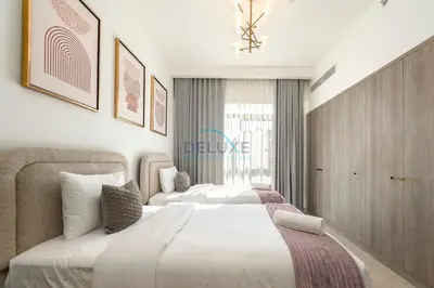 a hotel room with two beds and a window at Few Minutes Walk to Circle Mall, Conveniently Close Community Park, and Near the Bus Station for Effortless Metro Access - Oxford Terraces, JVC by Deluxe Holiday Homes in Dubai