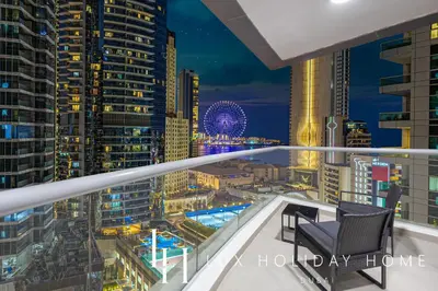 a balcony with a view of a city at night at LUX The Sky Dubai Eye View Suite in Dubai
