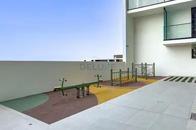 a group of benches on the side of a building at High-Floor Studio Overlooking the Community, Just a Short Drive to Miracle Garden, Binghatti Azure, JVC by Deluxe Holiday Homes in Dubai