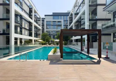 a swimming pool in the middle of a building at Bespoke Holiday Homes - 2BR plus Kids room in City Walk with Direct Pool Access in Dubai