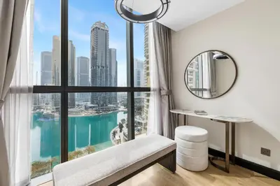 a bathroom with a large window with a view of the city at Modern 1BR by the Lake Near DMCC Metro Station in Dubai