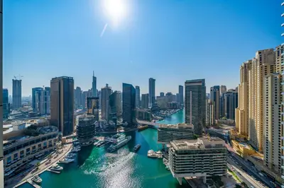 a view of a city with a river and buildings at Spacious 1BHK Apt with Canal View in Dubai Marina in Dubai