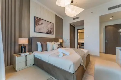 a bedroom with a large bed in a room at Direct Private Beach Access, Proximity To Key Dubai Attractions Like Dubai Marina, Palm Jumeirah, And JBR Walk - Palace Beach Residence Tower 2, Emmar Beachfront by Deluxe Holiday Homes in Dubai