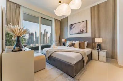 a bedroom with a large bed and a large window at Direct Private Beach Access, Proximity To Key Dubai Attractions Like Dubai Marina, Palm Jumeirah, And JBR Walk - Palace Beach Residence Tower 2, Emmar Beachfront by Deluxe Holiday Homes in Dubai