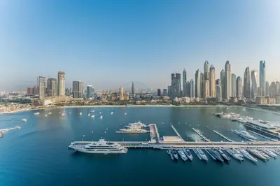 an aerial view of a harbor with boats and a city at Prestigious Waterfront Community, Beachfront Living Near Dubai Marina and Top Dining Hotspots - Palace Beach Residence Tower 2, Emaar Beachfront by Deluxe Holiday Homes in Dubai