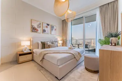a bedroom with a white bed and a large window at Prestigious Waterfront Community, Beachfront Living Near Dubai Marina and Top Dining Hotspots - Palace Beach Residence Tower 2, Emaar Beachfront by Deluxe Holiday Homes in Dubai
