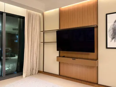 a living room with a flat screen tv on a wall at Address Opera in Dubai