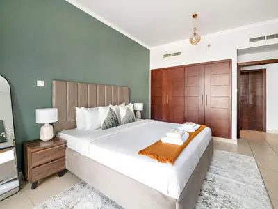 a bedroom with a large bed and a television at Serene 1BDR Unit -Burj Views, Downtown in Dubai