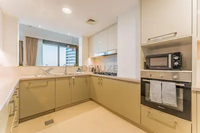 a kitchen with a stove and a microwave at High Floor with Direct Burj Khalifa and Fountain Views, Just Steps from Dubai Mall and Metro Station - Burj Vista Tower 1, Downtown Dubai by Deluxe Holiday Homes in Dubai