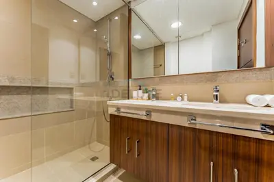 a bathroom with a shower and a sink and a mirror at High Floor with Direct Burj Khalifa and Fountain Views, Just Steps from Dubai Mall and Metro Station - Burj Vista Tower 1, Downtown Dubai by Deluxe Holiday Homes in Dubai
