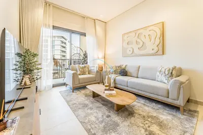 a living room with a couch and a table at Walking Distance to Miracle Garden and Butterfly Garden, 20 Minutes Drive to Dubai Marina and Palm Jumeirah - Divine Living, Arjan, by Deluxe Holiday Homes in Dubai