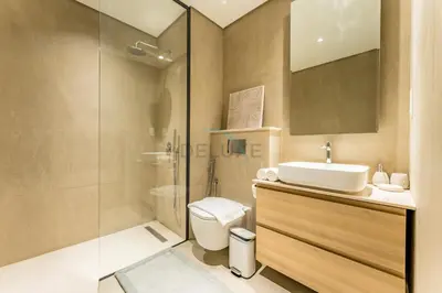 a bathroom with a toilet and a sink and a shower at Walking Distance to Miracle Garden and Butterfly Garden, 20 Minutes Drive to Dubai Marina and Palm Jumeirah - Divine Living, Arjan, by Deluxe Holiday Homes in Dubai