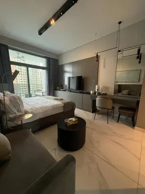 a bedroom with a bed and a living room at Furnished Studio 2 min Walk to Burji Khalifa in Dubai